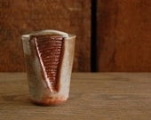 wheel thrown, altered and carved whiskey cup