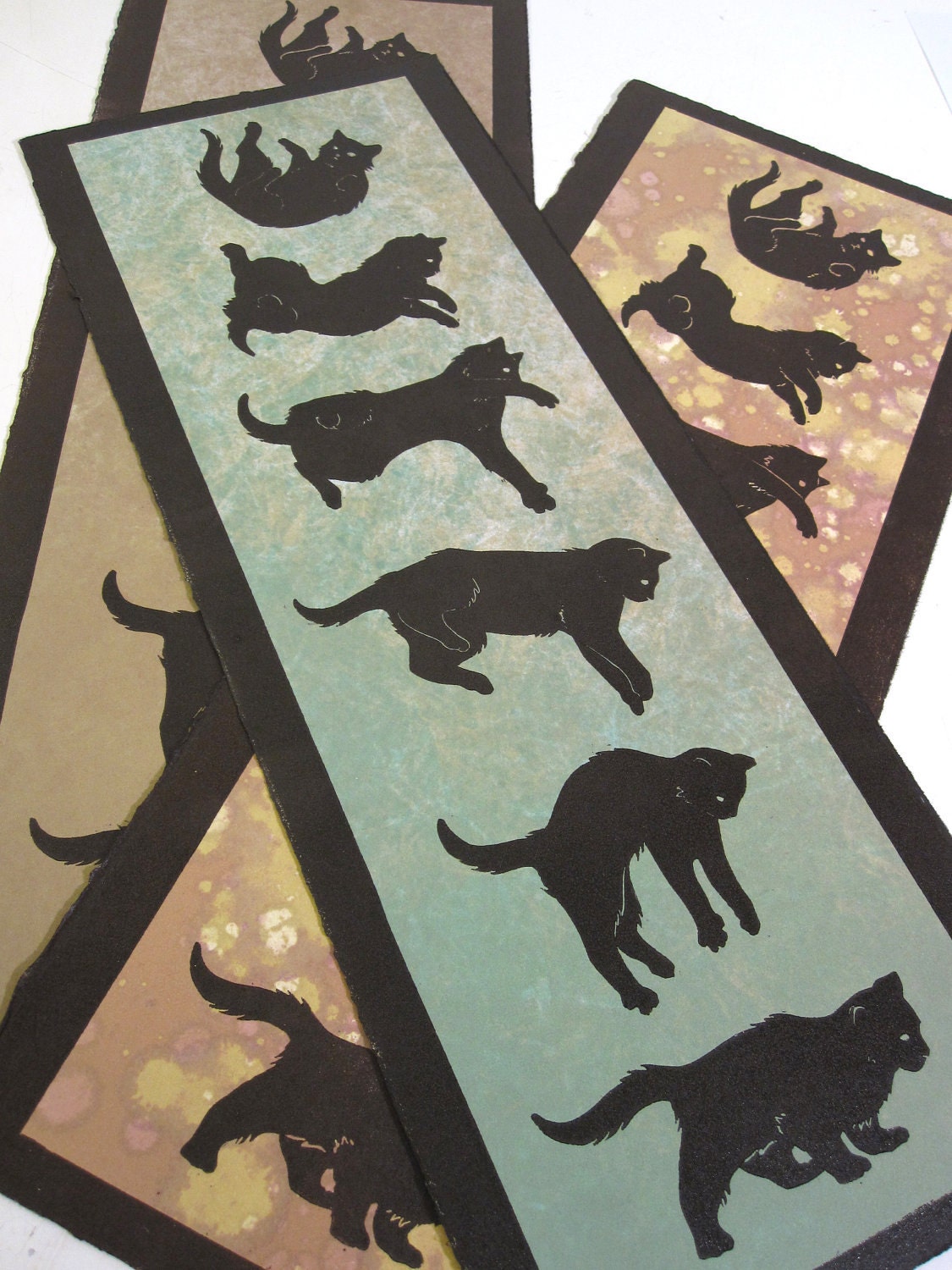 Righting Reflex III - falling cat original monoprint, relief block print over green and ochre monotype
