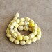 light yellow Magnasite candy beads 15 1/2 in (1 strand)