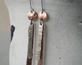 Artisan crafted dangle earrings of copper and sterling silver