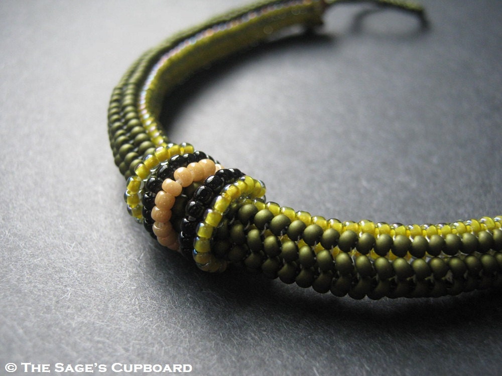 Olive Coil Bracelet. Green Handmade Beaded Rope Bracelet with Black and Beige Accent Loop Rings