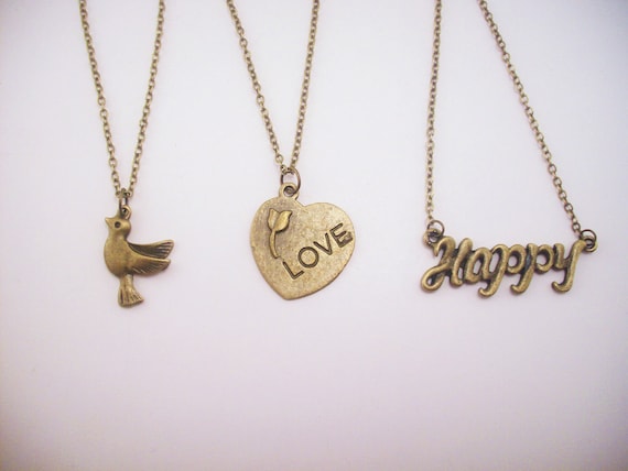 Set of three friendship necklaces. Peace, love, happiness. Brass, gold toned. Dove. Heart with flower. Best friend gift.
