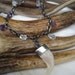 necklace with genuine lynx claw, crystal quartz and amethyst dangles