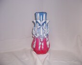 carved candle, red, white and blue