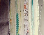 hanging LED candle lit tea-stained lace, fabric, and ribbon chandelier