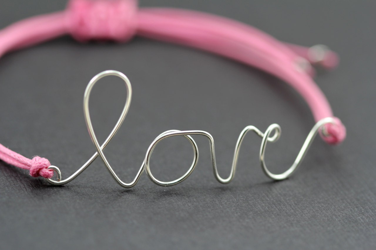 Love Bracelet : Candy Coated. Silver Handwritten Cursive Wire 'LOVE' Bracelet with Pink Cotton Cord, Adjustable, Crimp Beads