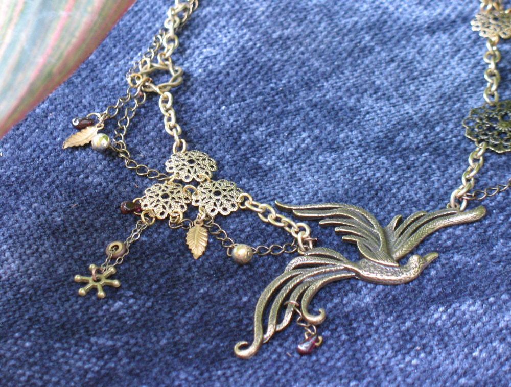 Neo-Victorian / Steampunk gold-toned necklace with bird pendant and garnets
