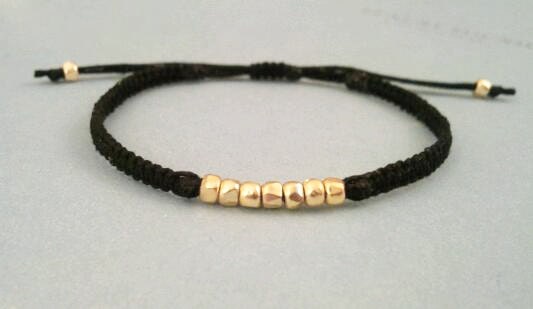 simple stackable gold nuggets friendship bracelet on adjustable cotton macrame. maggie.