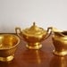 Vintage gold porcelain sugar, creamer, and footed bowl