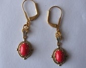 Goldplated pierced dangle earrings with red tea bead charms