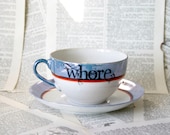 Orange and blue WHORE teacup and saucer set