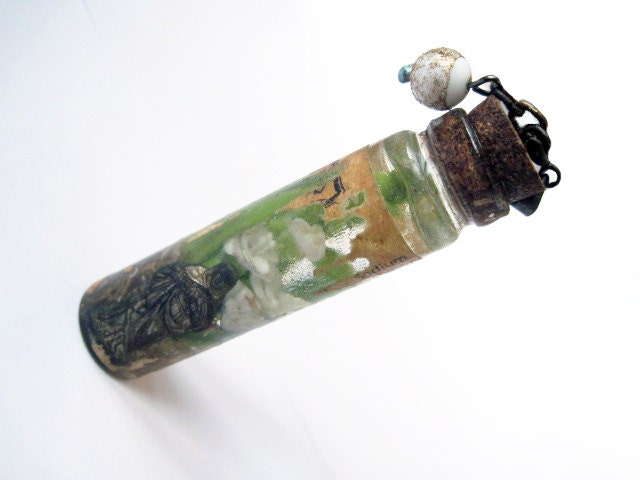 A Perfect Harmony. Bottle resin pendant with miniature flowers and tiny metal mary saint.