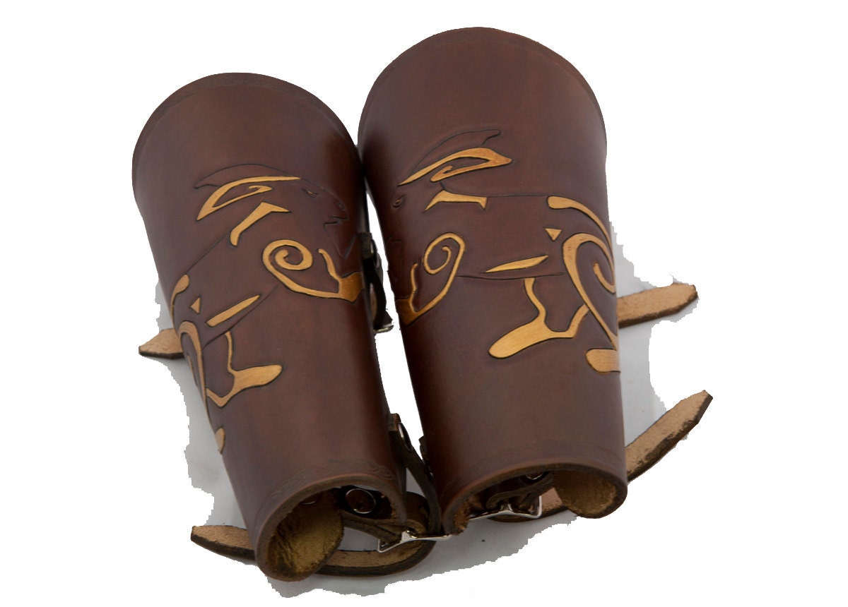 Dark brown leather bracers with gold accented celtic rabbit armor cuff