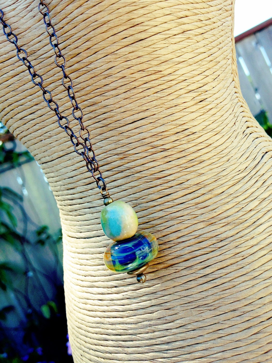 Long, simple, pendant style artisan necklace. Wire wrapped boro lampwork bead, ceramic focal, Vintaj Natural Brass