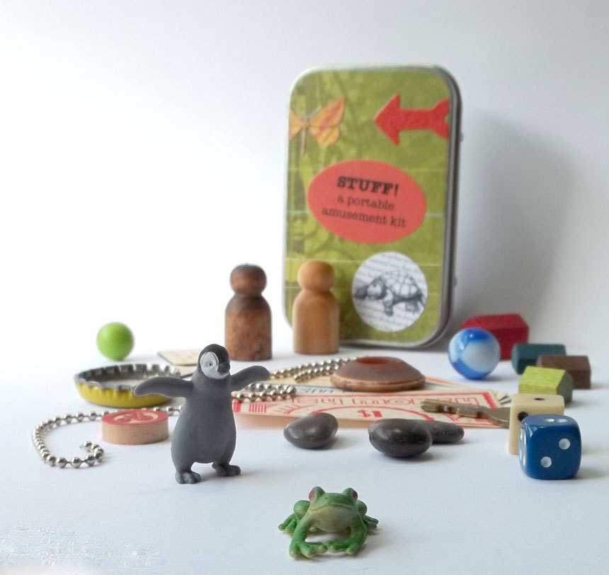 Small toys with tiny frog and penguin in a little tin box