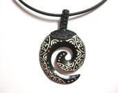 Beautiful black and white bone pendant on a black leather necklace