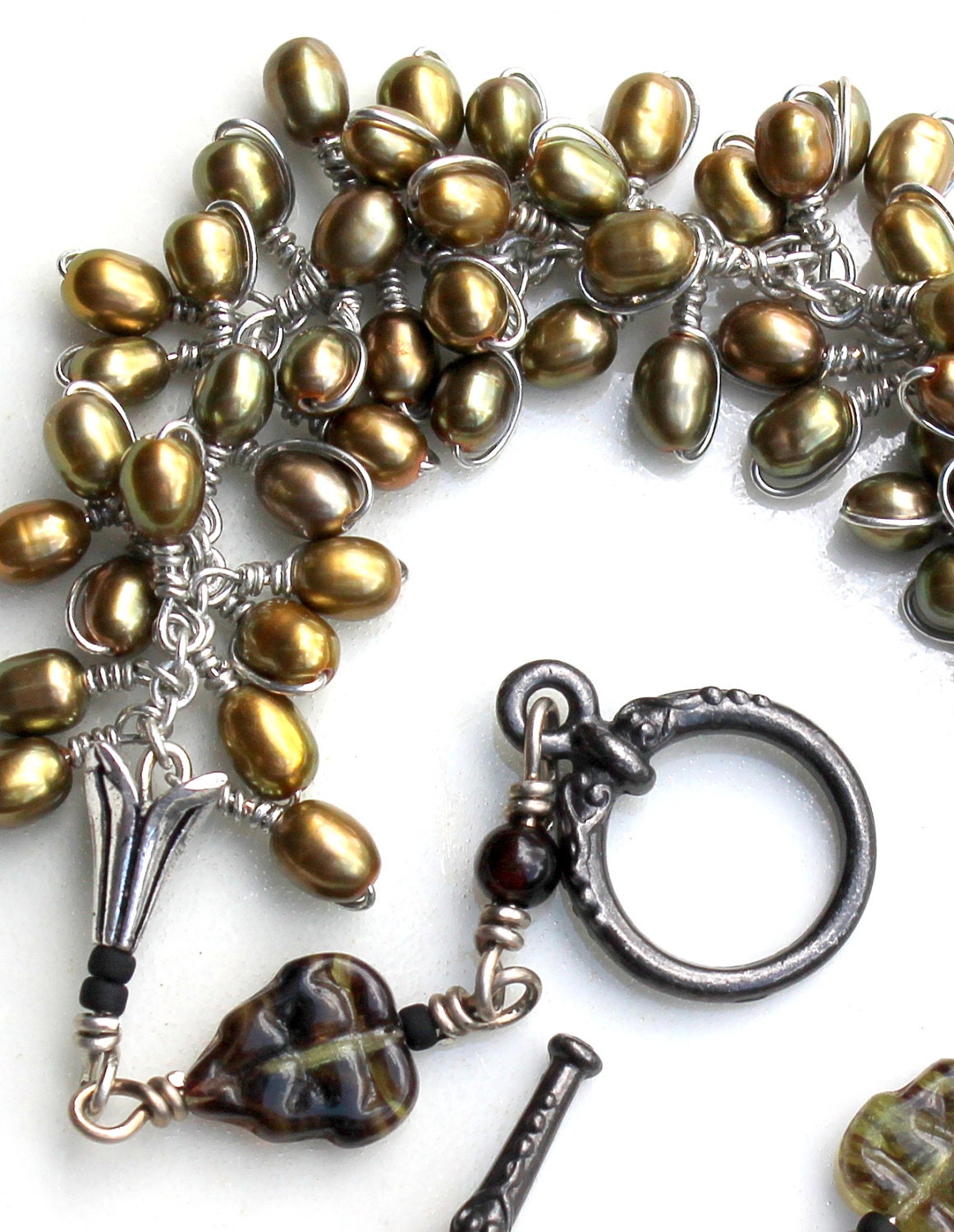 The green olive. pearl wrapped bracelet. green czech glass leaves. gothic wire wrapped jewelry