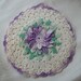 Hand crocheted hot pad or wall decoration with small loop for hanging.