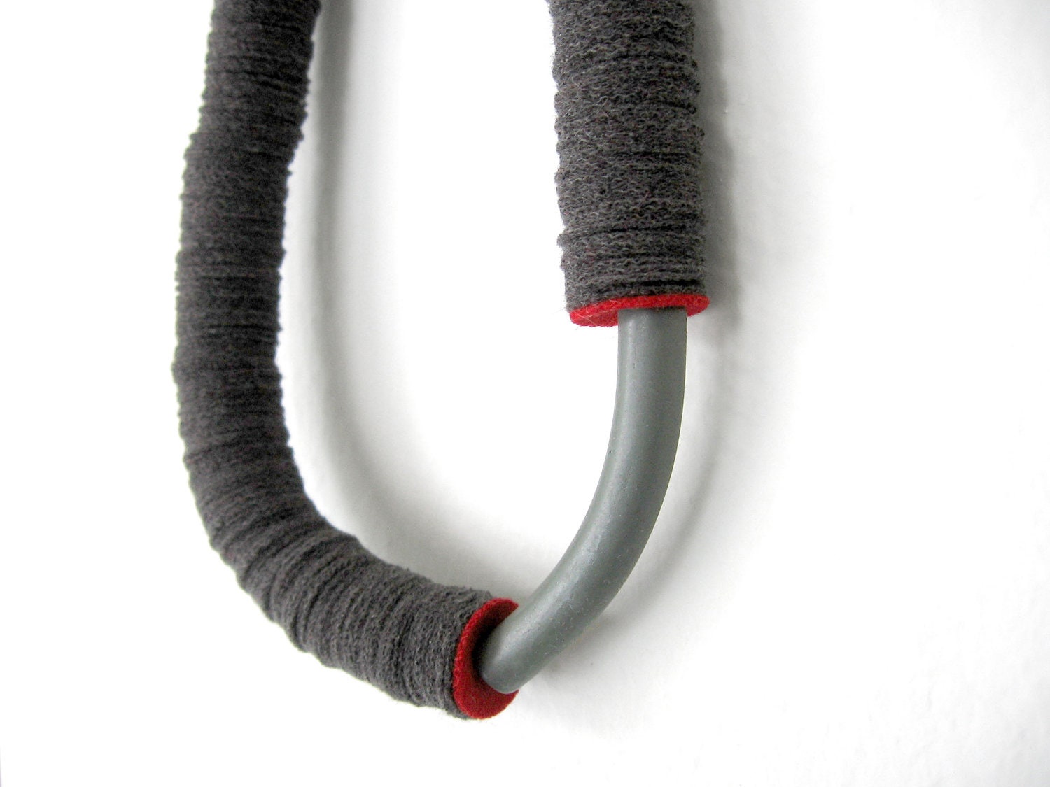 grey tube minimal geometric necklace with an arc ceramic bead and a red touch
