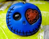 Navy blue skull keychain with a great red heart in his eye. Cute mini monser in deep blue