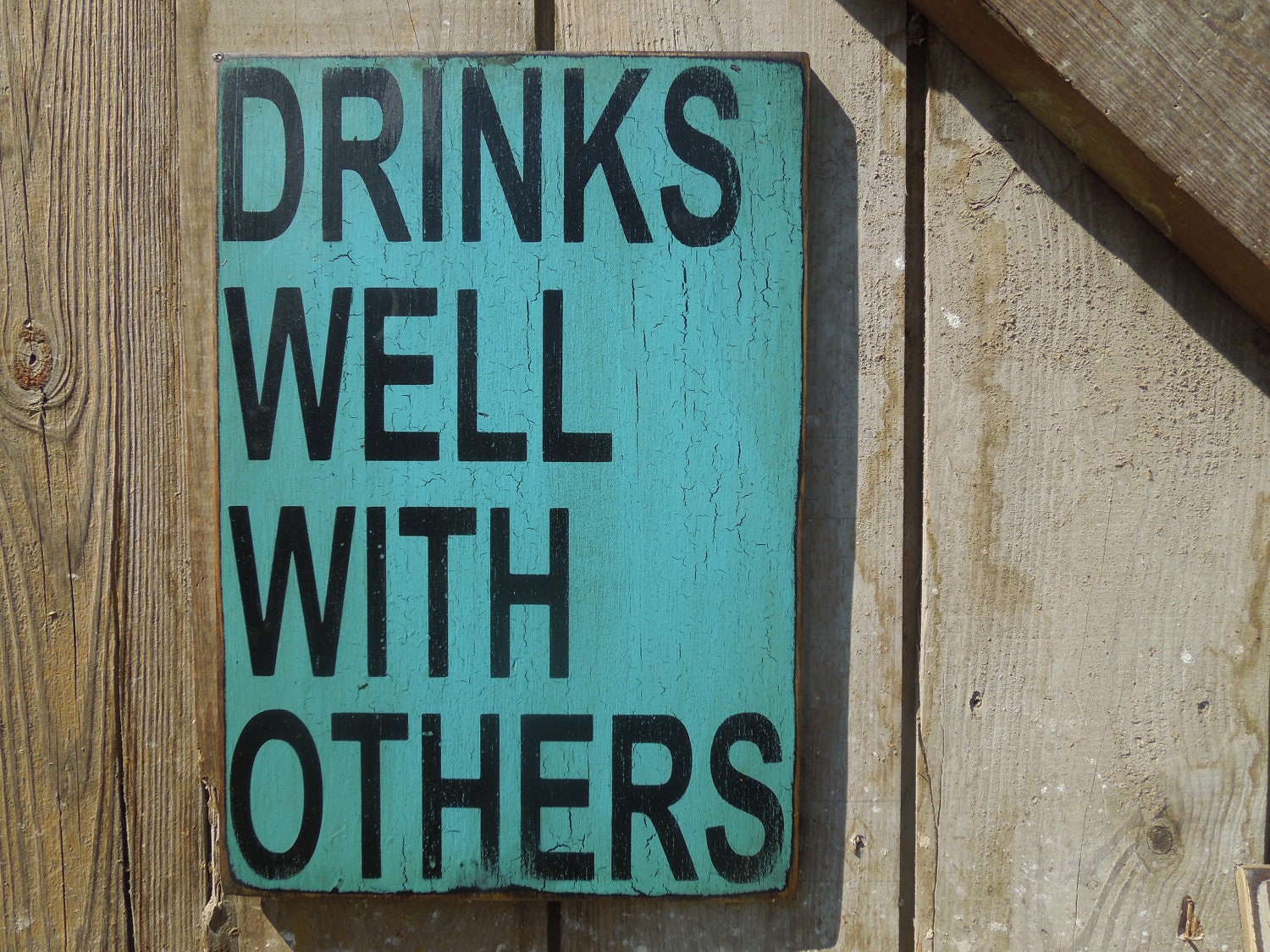 Drinks well with others sign made from reclaimed plywood