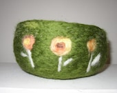 three yellow flowers on a field of green, a needle felted wool bowl