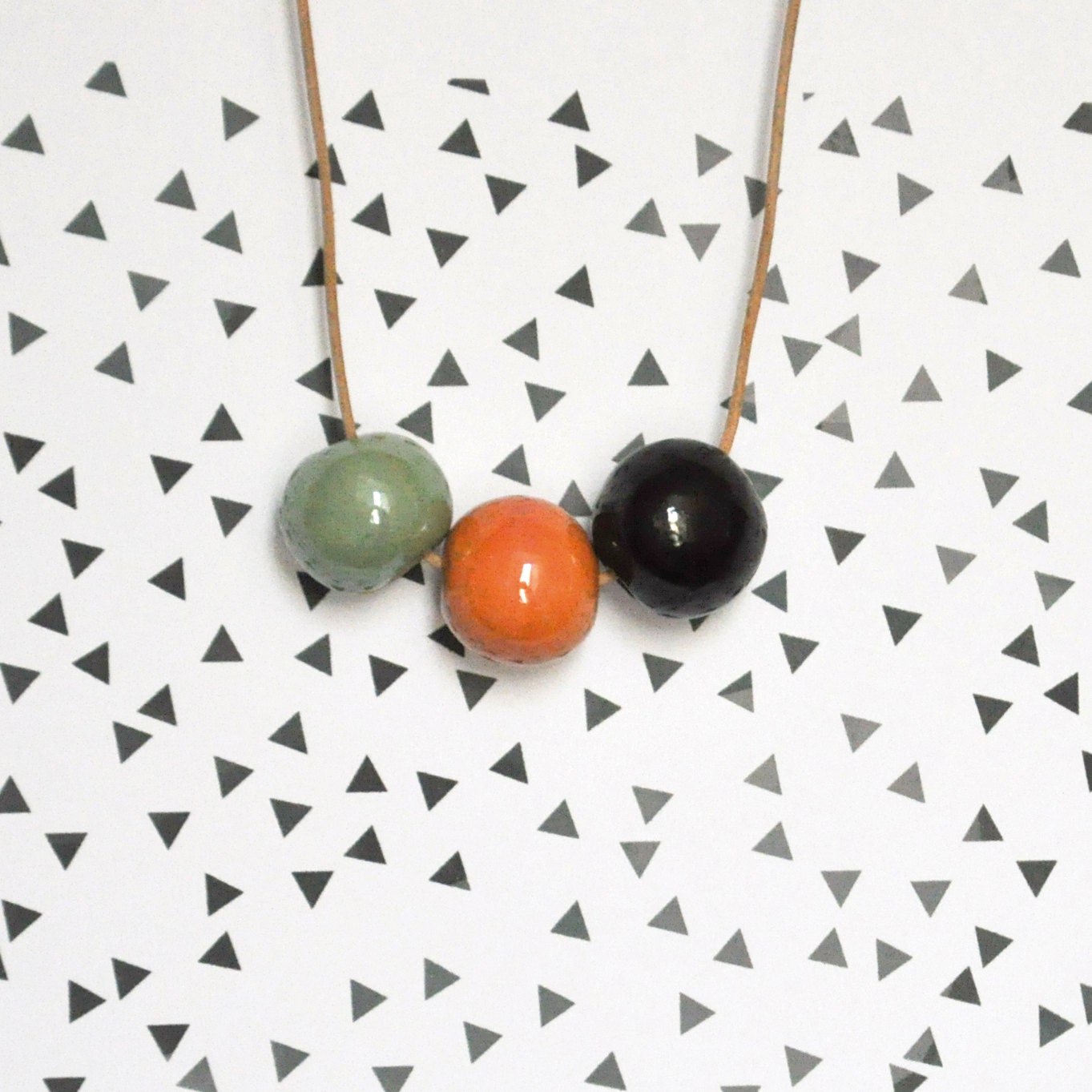 Ceramic bead necklace .  Handmade ceramic bead / Pale green, orange and black - oelwein