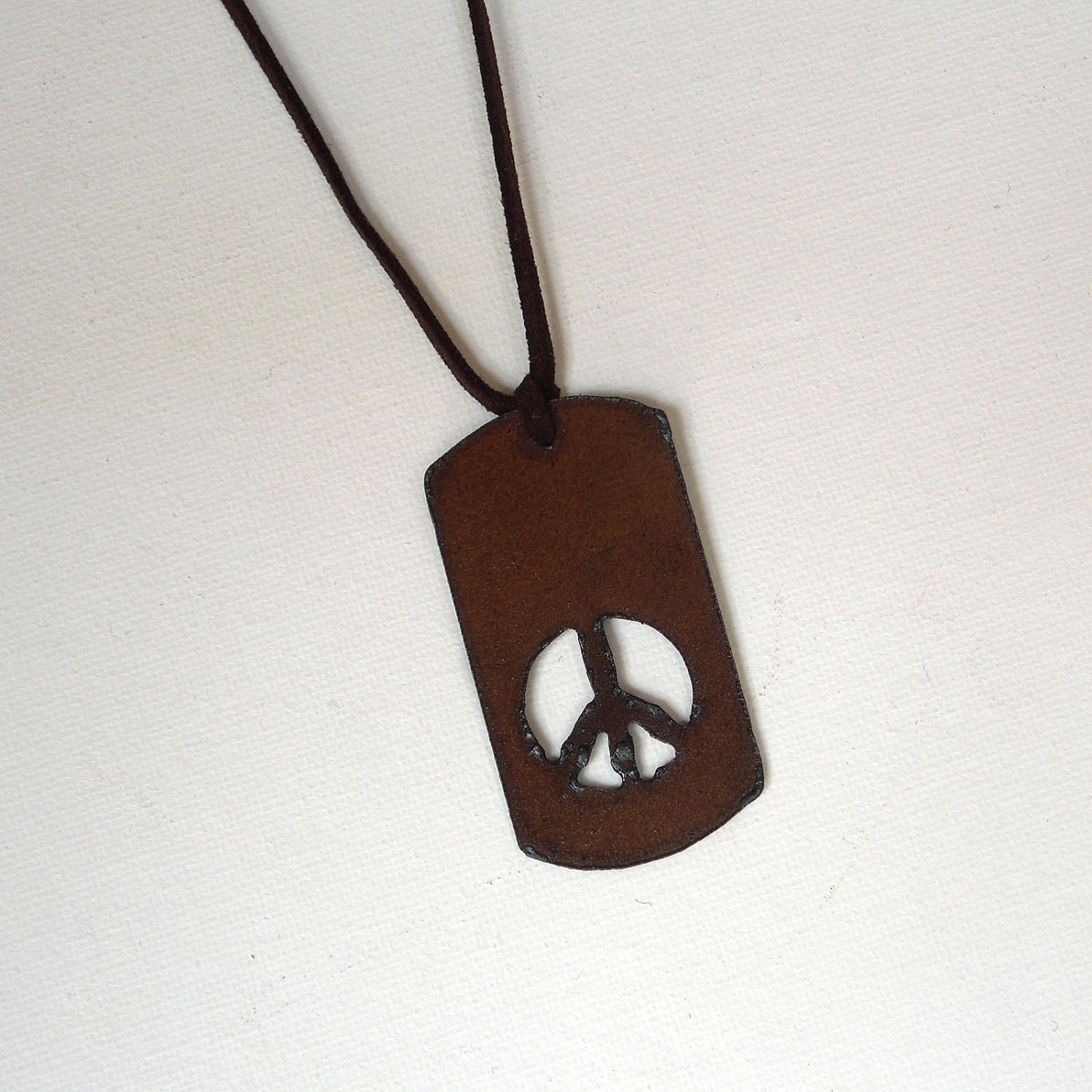 Metallic peace symbol on brown leather cord  Unisex