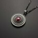 Round silver pendant with heat patinaed red copper