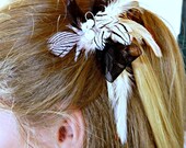 Hair clip of black and white feathers attached to a background black bow.