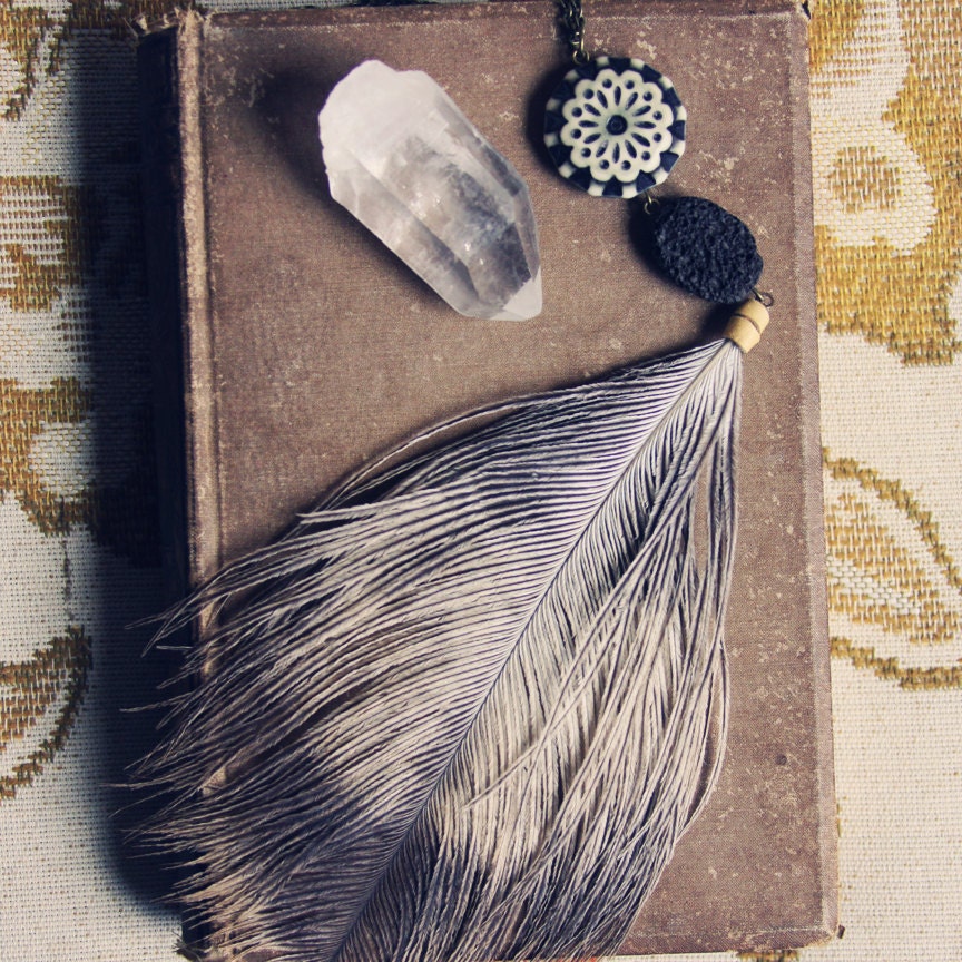 uma.  a black and white ostrich feather necklace.