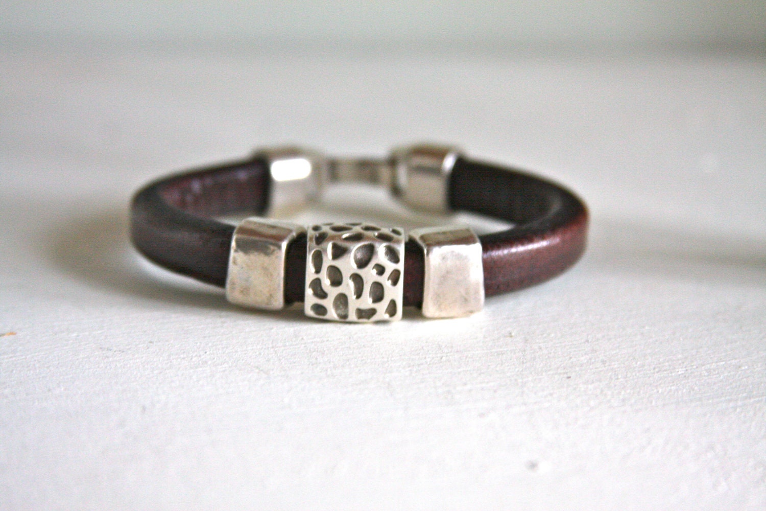 Regaliz leather bracelet in distressed brown with silver animal pattern slide beads and silver clasp