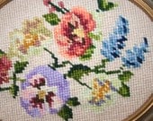 pair of oval  framed needlepoint flowers