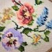 pair of oval  framed needlepoint flowers