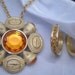 Napier gold aphrodite brooch/pendant with orange cabochons and rhinestone with matching pierced earrings
