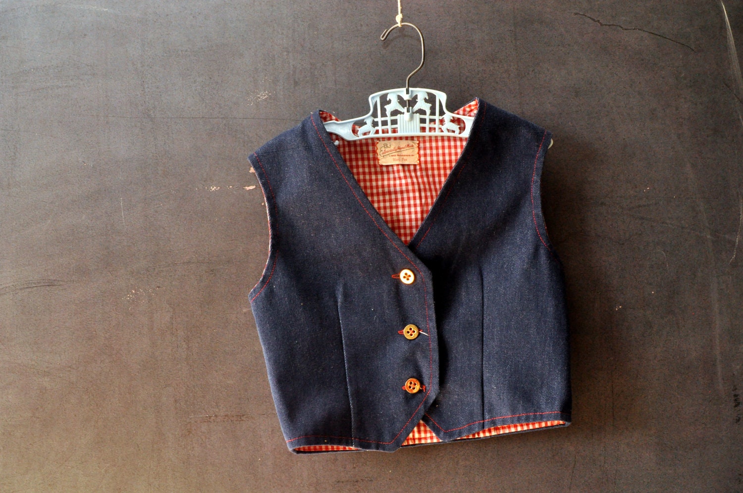Kids vtg denim blue jean vest, with red and white gingham lining, red stitching, gold buttons