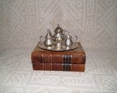Child silver plate tea set with teapot, sugar and creamer