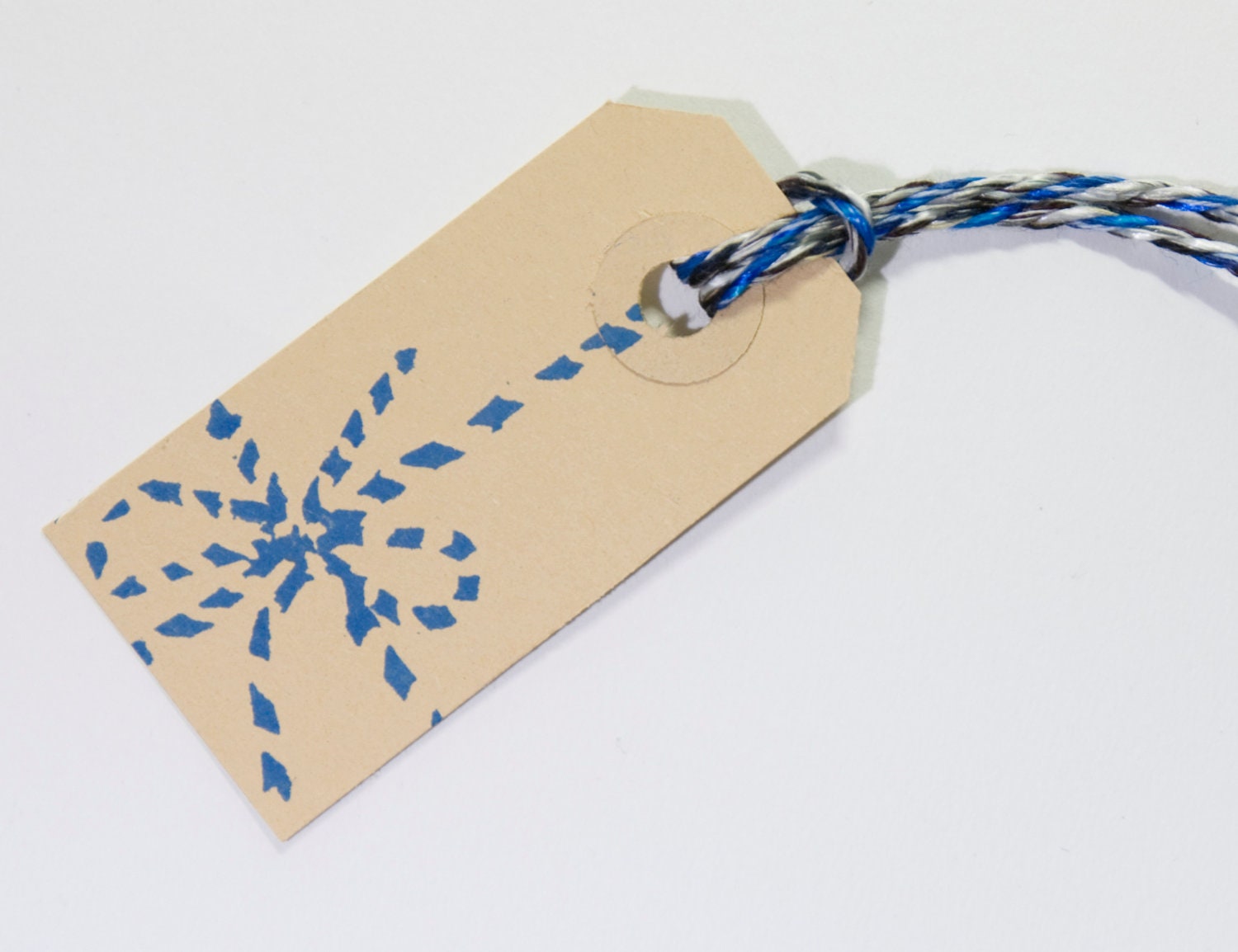 Gift tags kraft hand stamped, with a twine bow stamp in blue, with blue twine