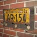 Vintage coat rack made with a real vintage license plate- Fathers Day-barnwood- and vintage brass hooks- NEW YORK