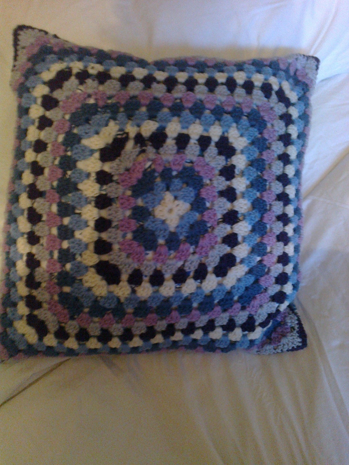 hand crochet granny square cushion (pillow) made from wool rich yarn backed in vintage fabric