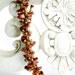 Woven spiral rope bracelet featuring goldstone chips and a magnetic clasp