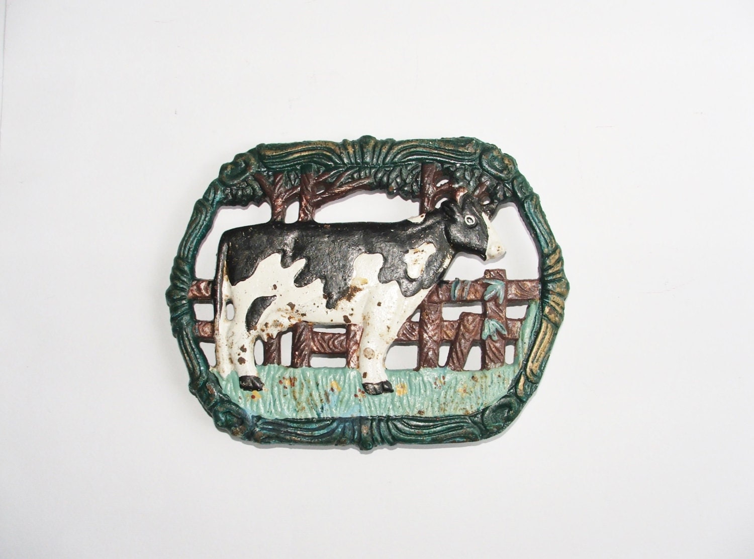 Cast iron stand. For farm house kitchen, rustic, shabby chic style,cute looking black and white cow, farm yard, brown, green grass.