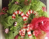 Christmas Wreath with Candy Canes and Peppermints, green Deco Mesh wreath with red and white peppermints and candy canes, and a red bow
