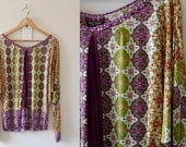 M Batwing jersey top, green and purple patterns (size 10-12)