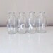 LOVE Four upcycled glass mini milk bottles.Great WEDDING decor.
