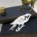 Paper-cut Scherenschnitte silhouette Finch on a Twig in Snow White
