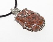 Red and black spotted beach stone pendant necklace