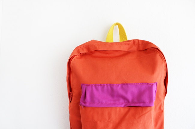 orange backpack with magenta pouch