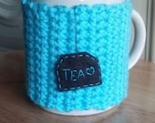 Crocheted tea mug cozy cup cozy in aqua blue aruba sea blue turquoise with hanging brown tea patch