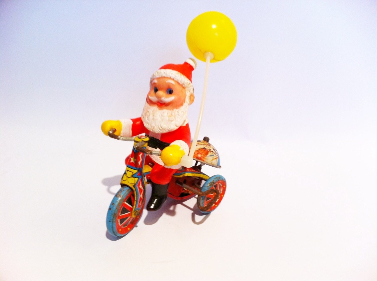 Vintage Santa Claus Tin Litho wind up with key. Japan. Bicycle balloon. Red, white blue. Christmas toy.  1950s